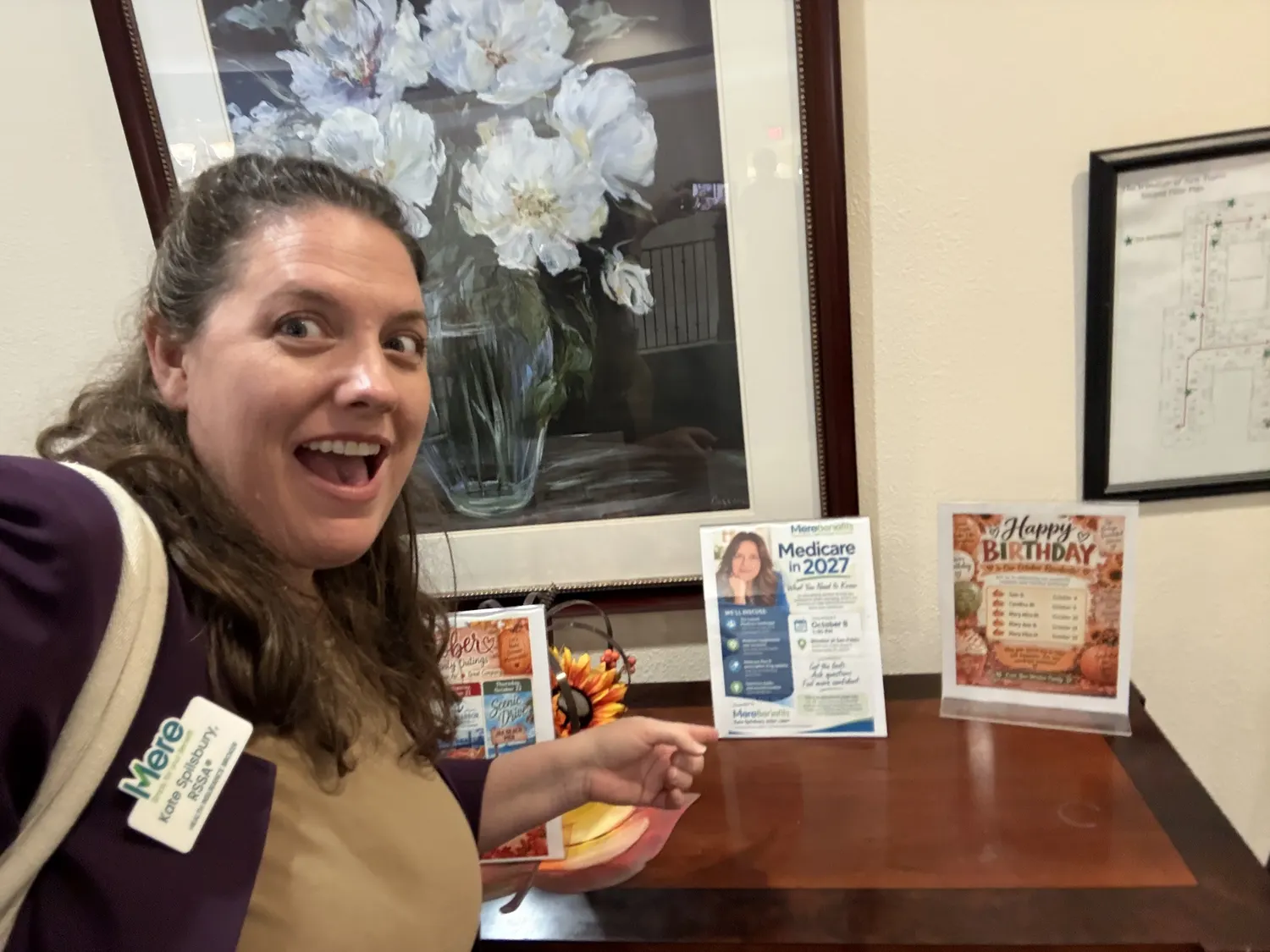 Kate Spilsbury beside the welcome table, where the printed seminar flyer was displayed