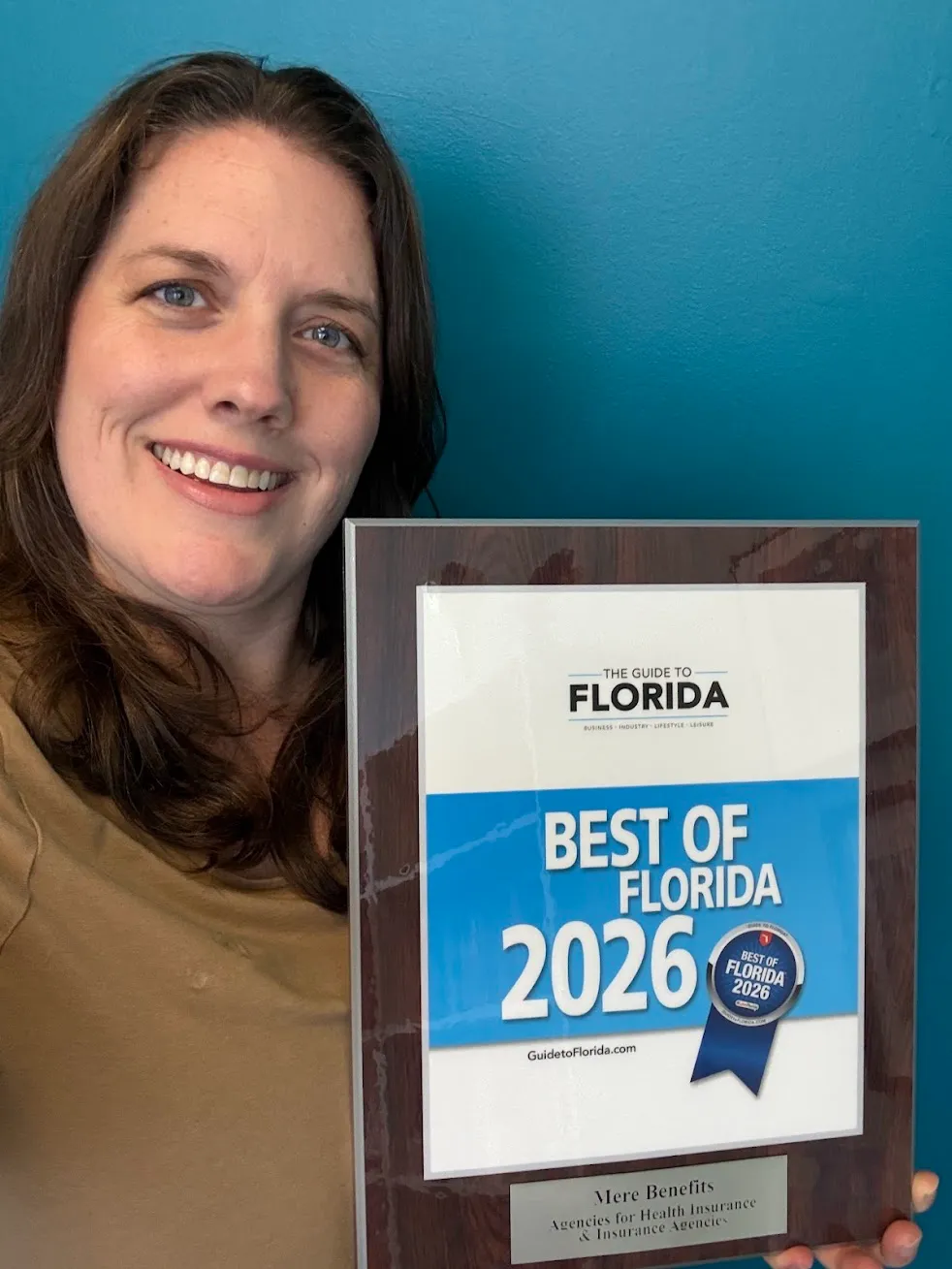 Kate Spilsbury holding the Best of Florida 2026 award plaque