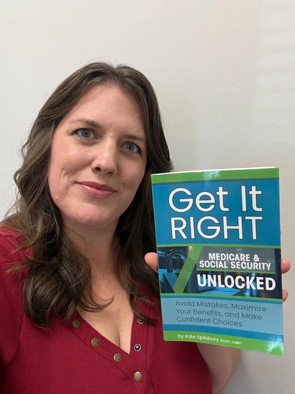 Kate Spilsbury holding her book, Get It Right: Medicare and Social Security Unlocked
