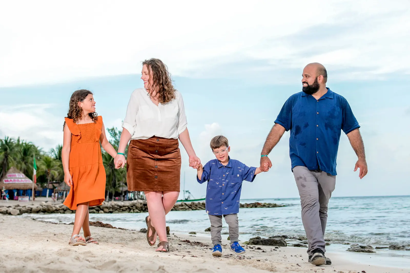 Kate Spilsbury walking on the beach with her husband and two kids