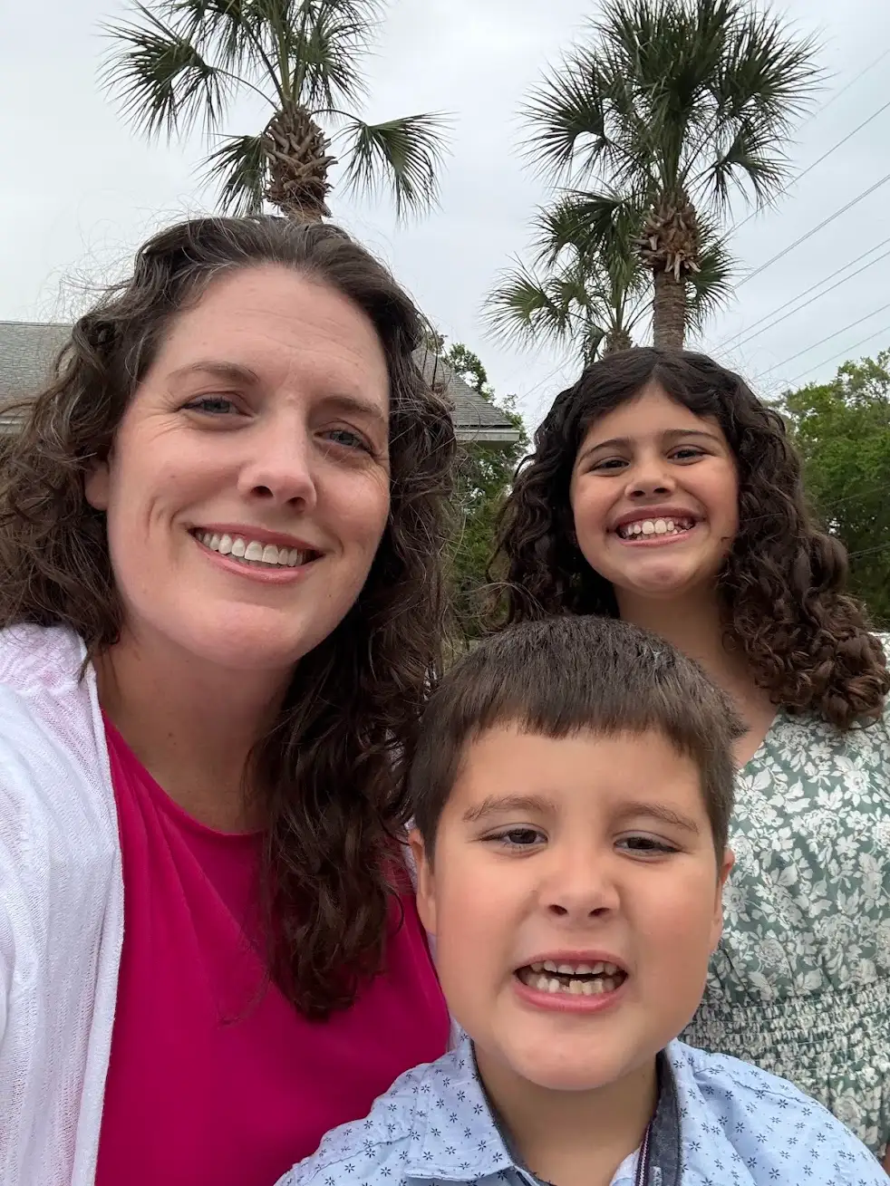 Kate Spilsbury with her two children under Florida palms