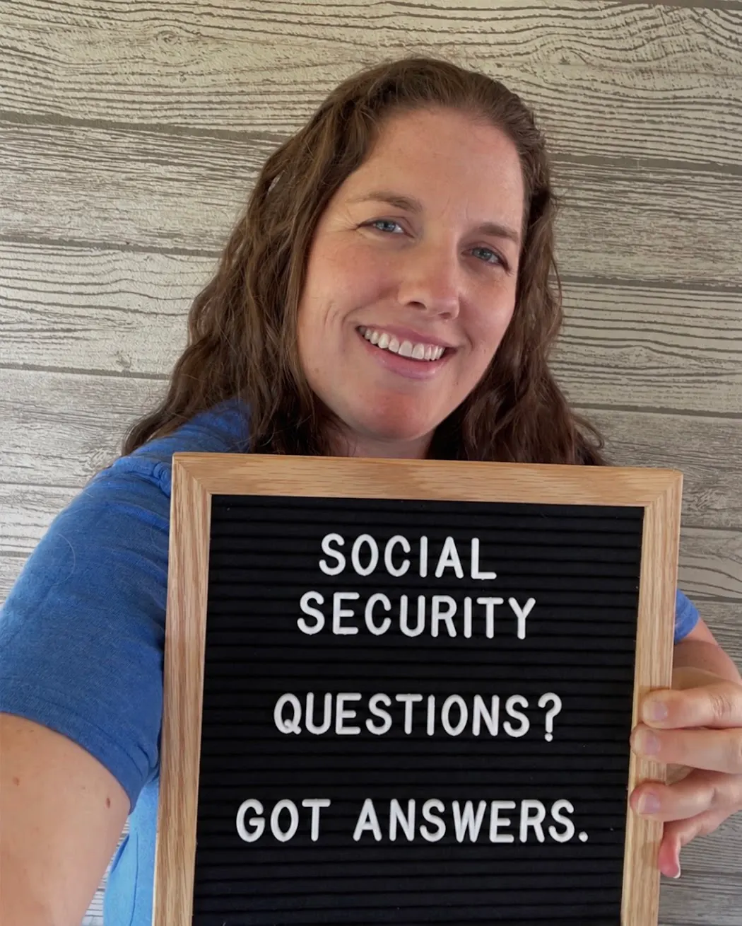 Kate Spilsbury holding a sign reading Social Security questions? Got answers.